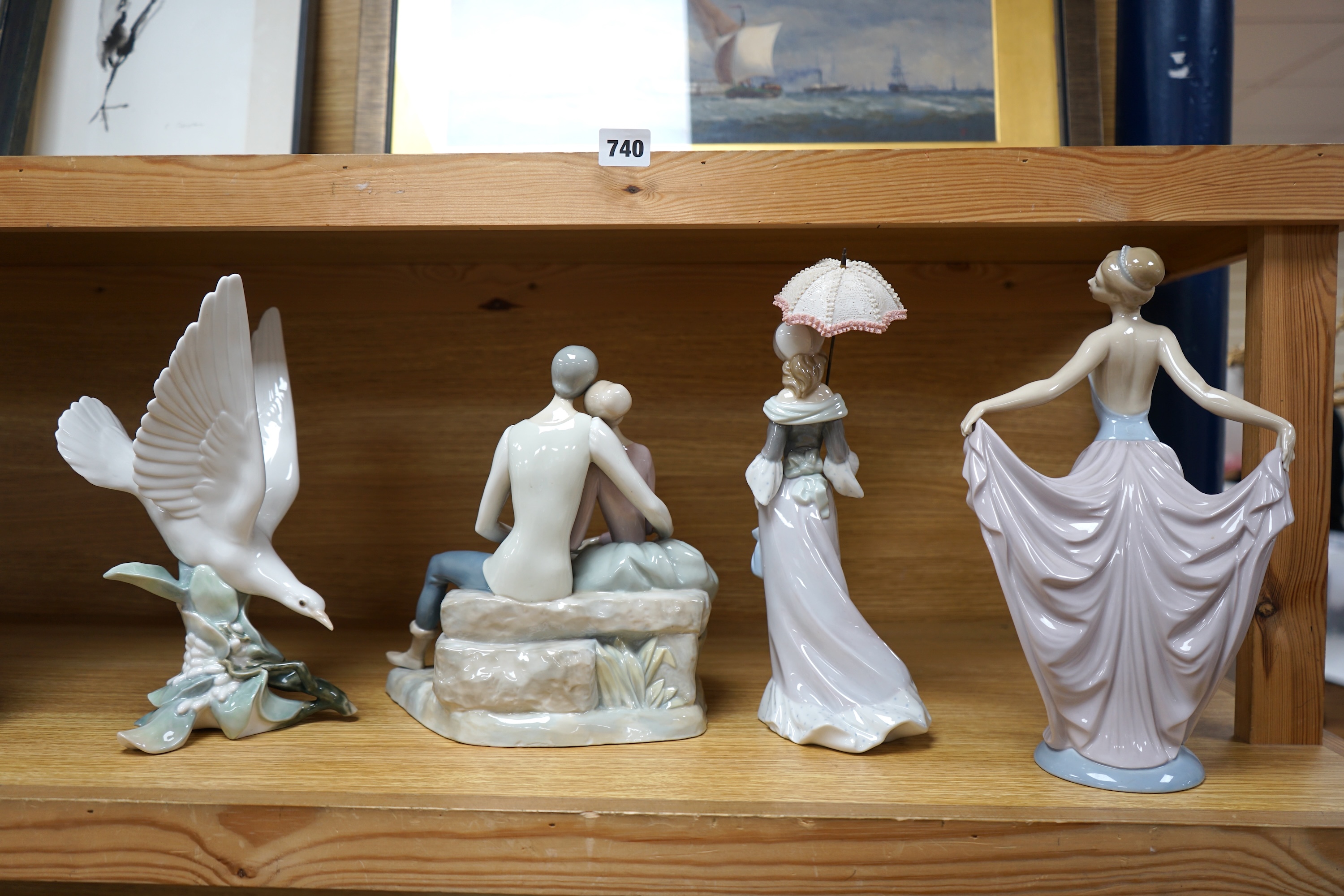 Three Lladro figure groups to include a dancer and a seagull together with another Spanish porcelain group, largest 31cm high. Condition - good